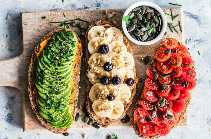 assorted fruits and vegetable on brown wooden chopping board