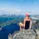 woman sitting on mountain cliff