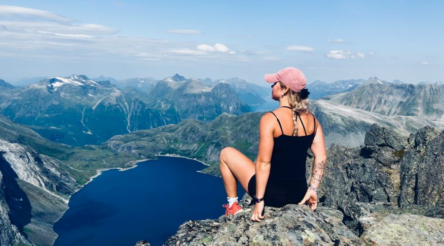 woman sitting on mountain cliff