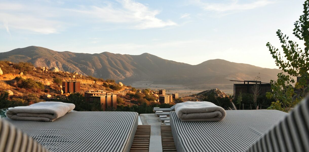 sunloungers fronting buildings near mountain