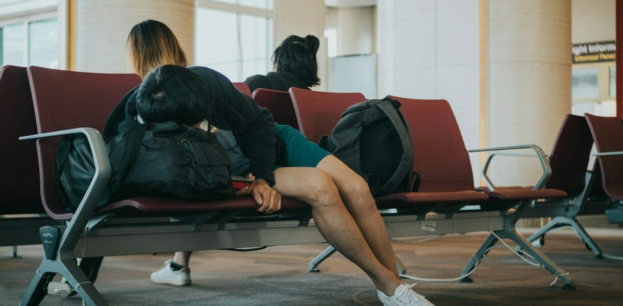 unknown person lying on brown bench indoors