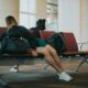 unknown person lying on brown bench indoors