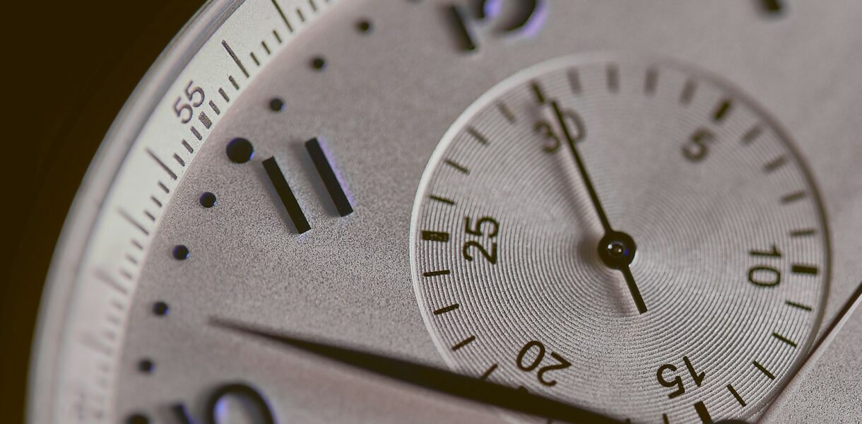 a close up of a silver watch face