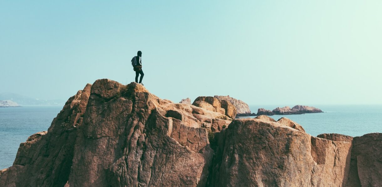 man stands on top of mountain