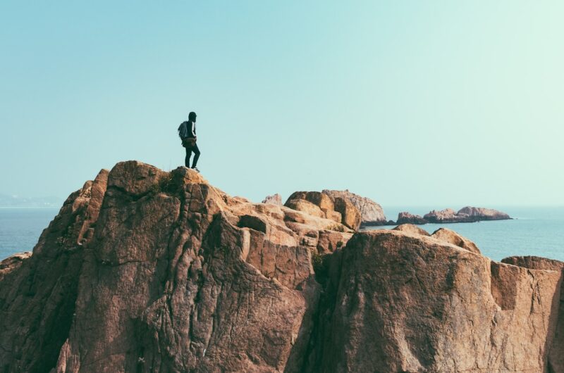 man stands on top of mountain