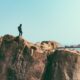 man stands on top of mountain