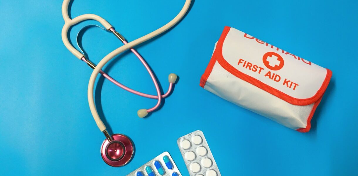 a bag of pills, a stethoscope, and a first aid kit